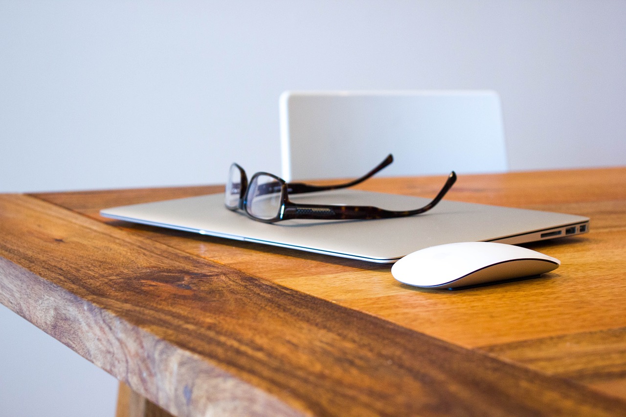 Desk with laptop and notebook